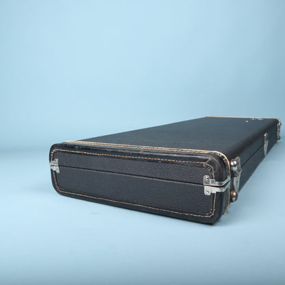 End view of black Fender guitar case showing stitched leather trim