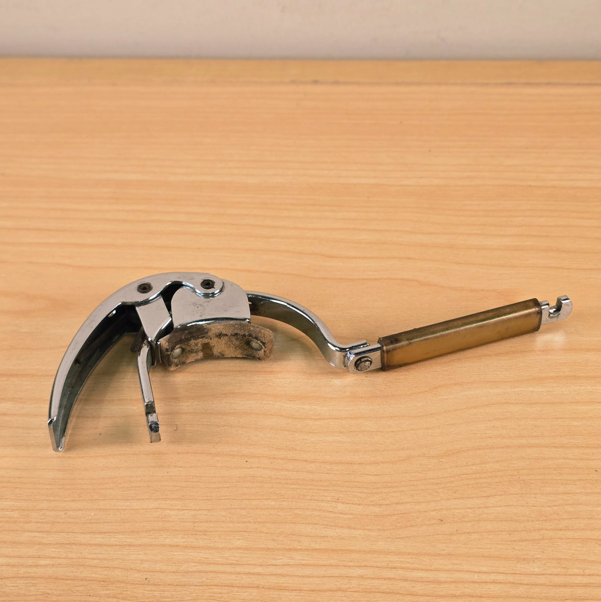 Close-up underside view of the unlatched Hamilton KB19A capo mechanism.