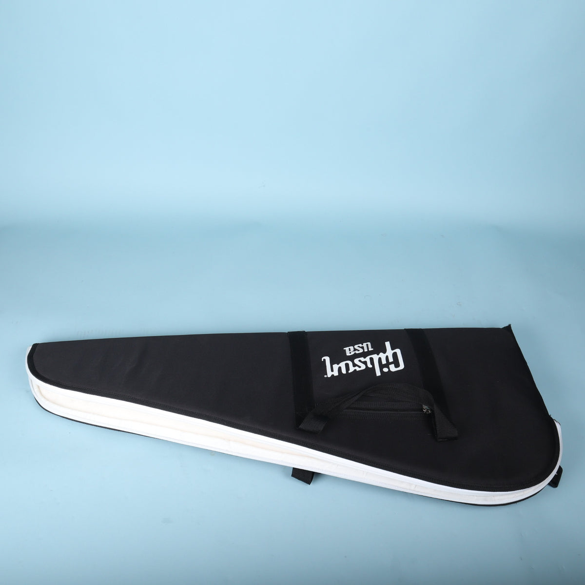 Profile view of the closed gig bag showing the white zipper trim along the outer edge.