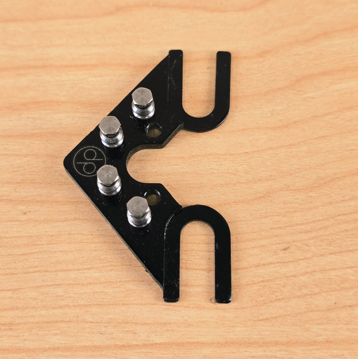 Top view showing the four roller posts and engraved dp logo on the String Butler V3