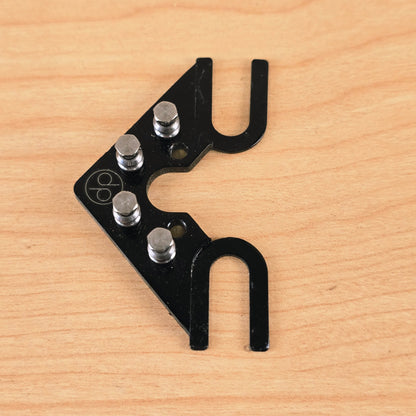 Top view showing the four roller posts and engraved dp logo on the String Butler V3