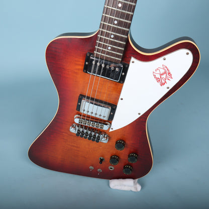 Front angled view of the Gibson Firebird II Artist body showing the sunburst flame maple top, pickups, bridge, and controls.