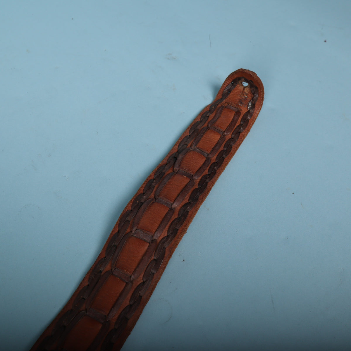 Narrow strap end with keyhole buttonhole and whipstitched border