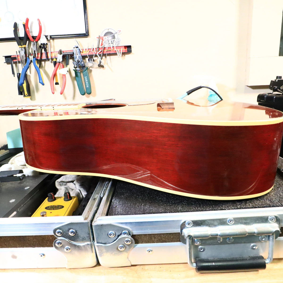Opposite side profile of the guitar body on the workbench.