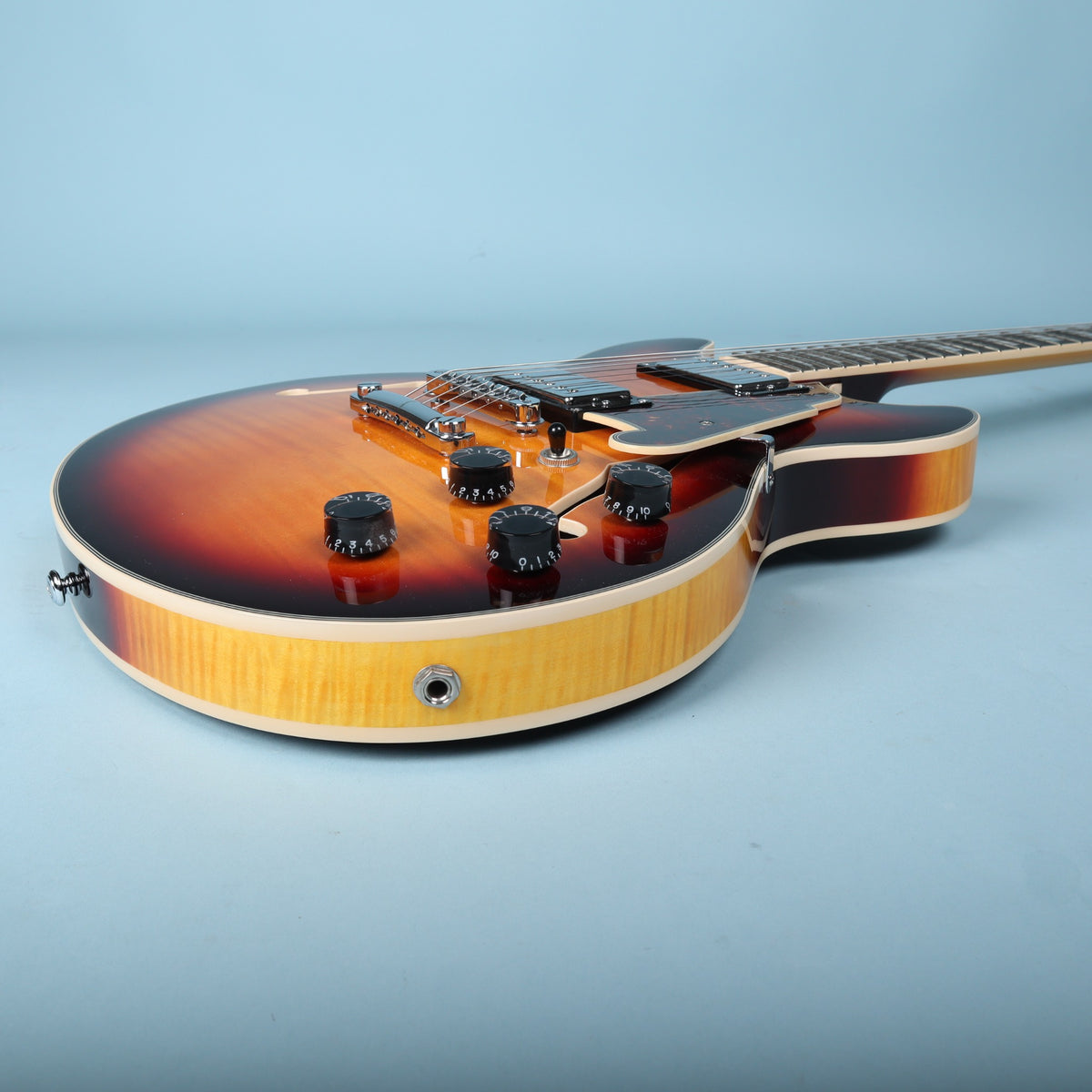 Lower bout rim profile showing cream binding and quarter-inch output jack.