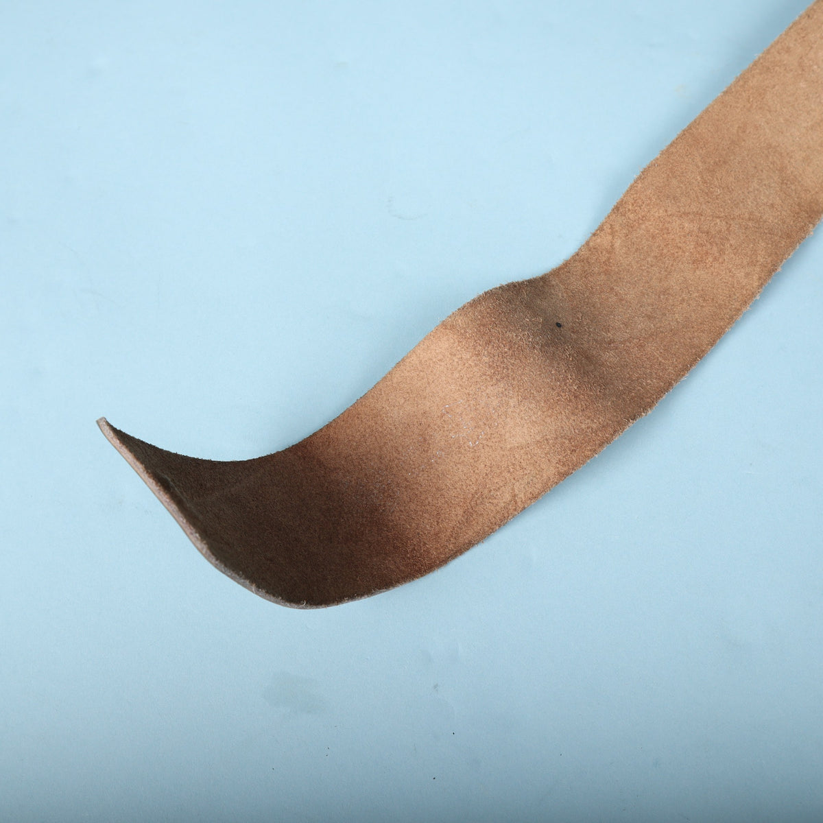 View of the natural suede backing on the underside of the guitar strap