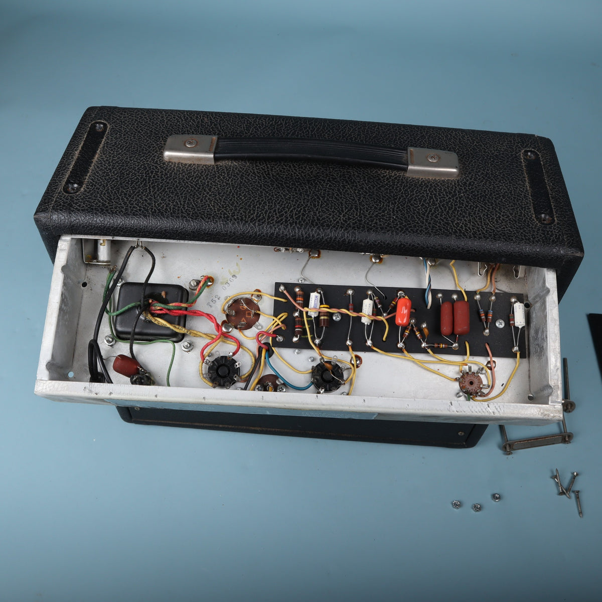 Overhead view of the opened chassis showing hand-wired eyelet board circuitry.