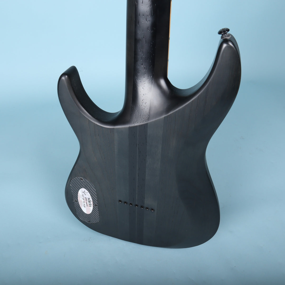 Close-up of the sculpted neck joint and string ferrules on the rear body