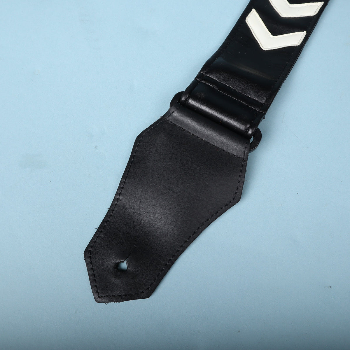 Front view of the stitched leather end tab with button hole