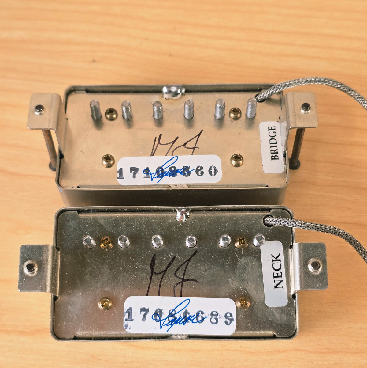 Detail of pickup baseplates showing MJ signatures and neck and bridge stickers