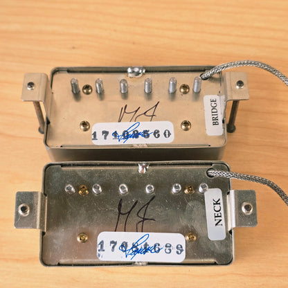 Detail of pickup baseplates showing MJ signatures and neck and bridge stickers