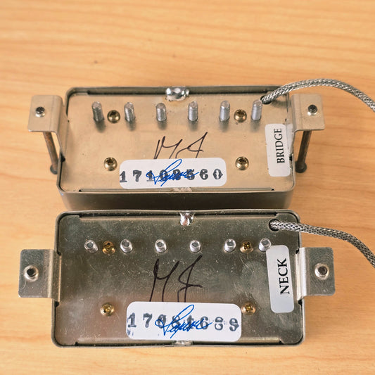 Detail of pickup baseplates showing MJ signatures and neck and bridge stickers