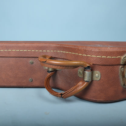 Detail of the brown padded handle showing some wear and split wrap