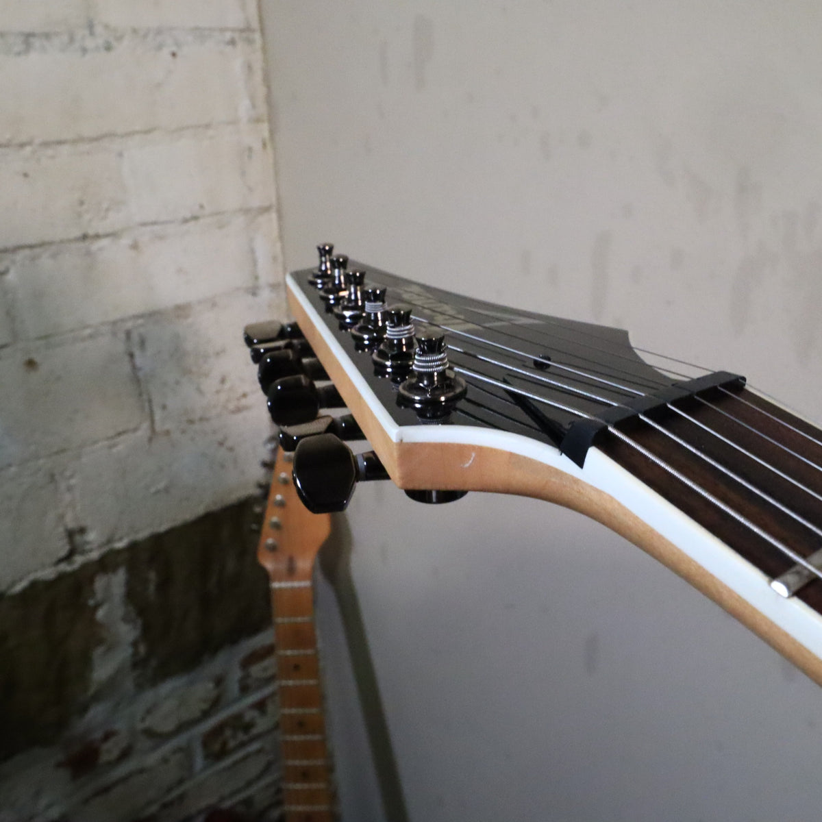 Angled view of headstock tip and tuners on workbench