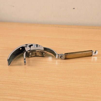 Hamilton KB19A capo unlatched and resting flat on a wooden surface.