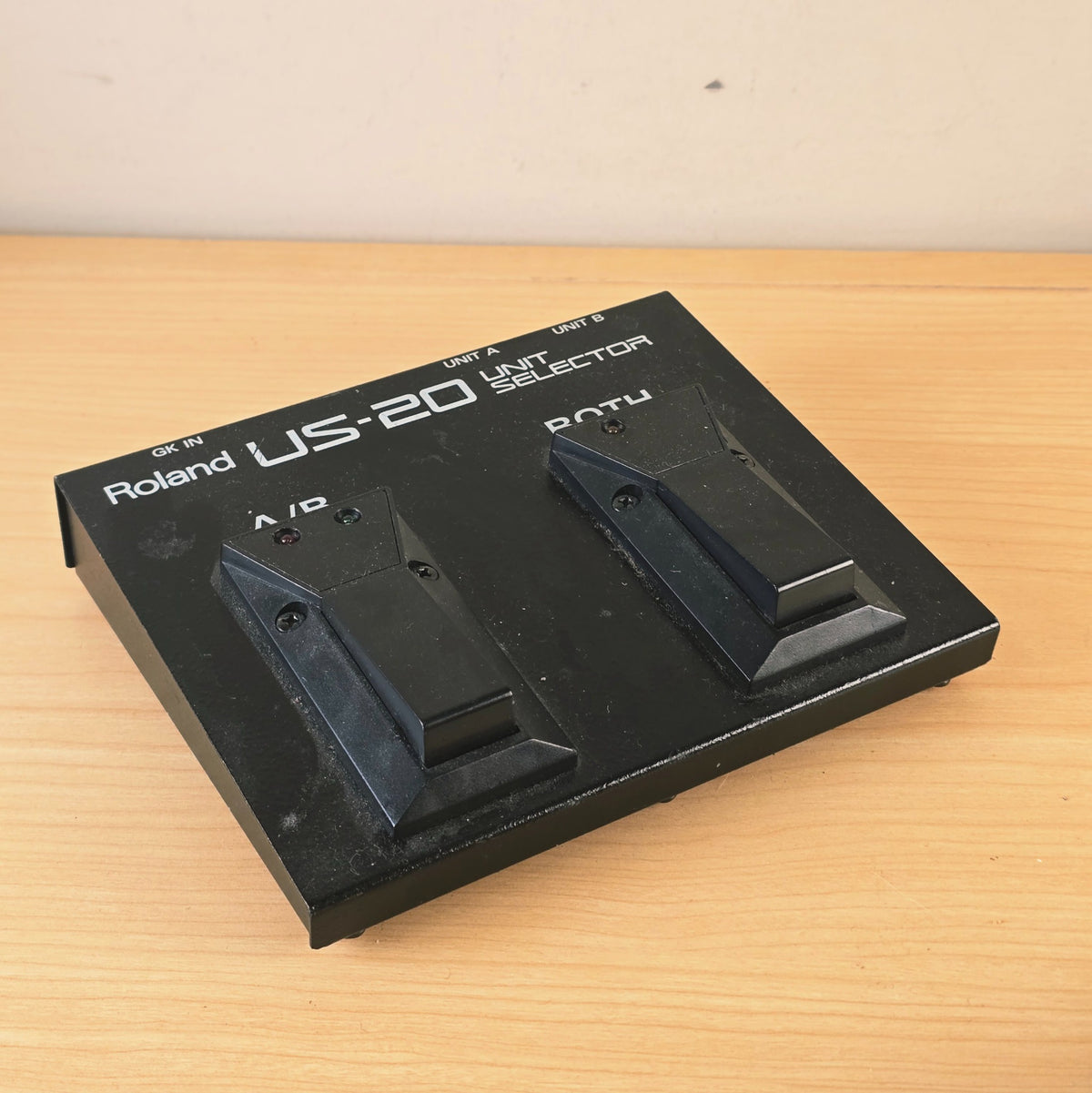Front perspective view of the Roland US-20 unit selector showing footswitch layout.