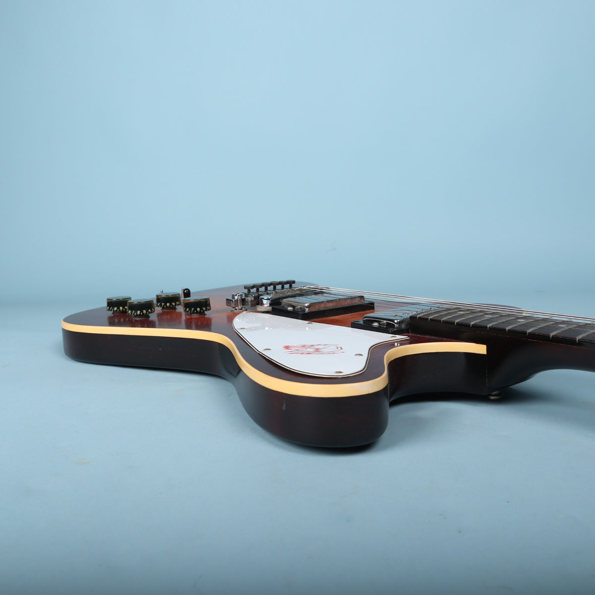 Treble cutaway profile view showing the body contours and white pickguard.
