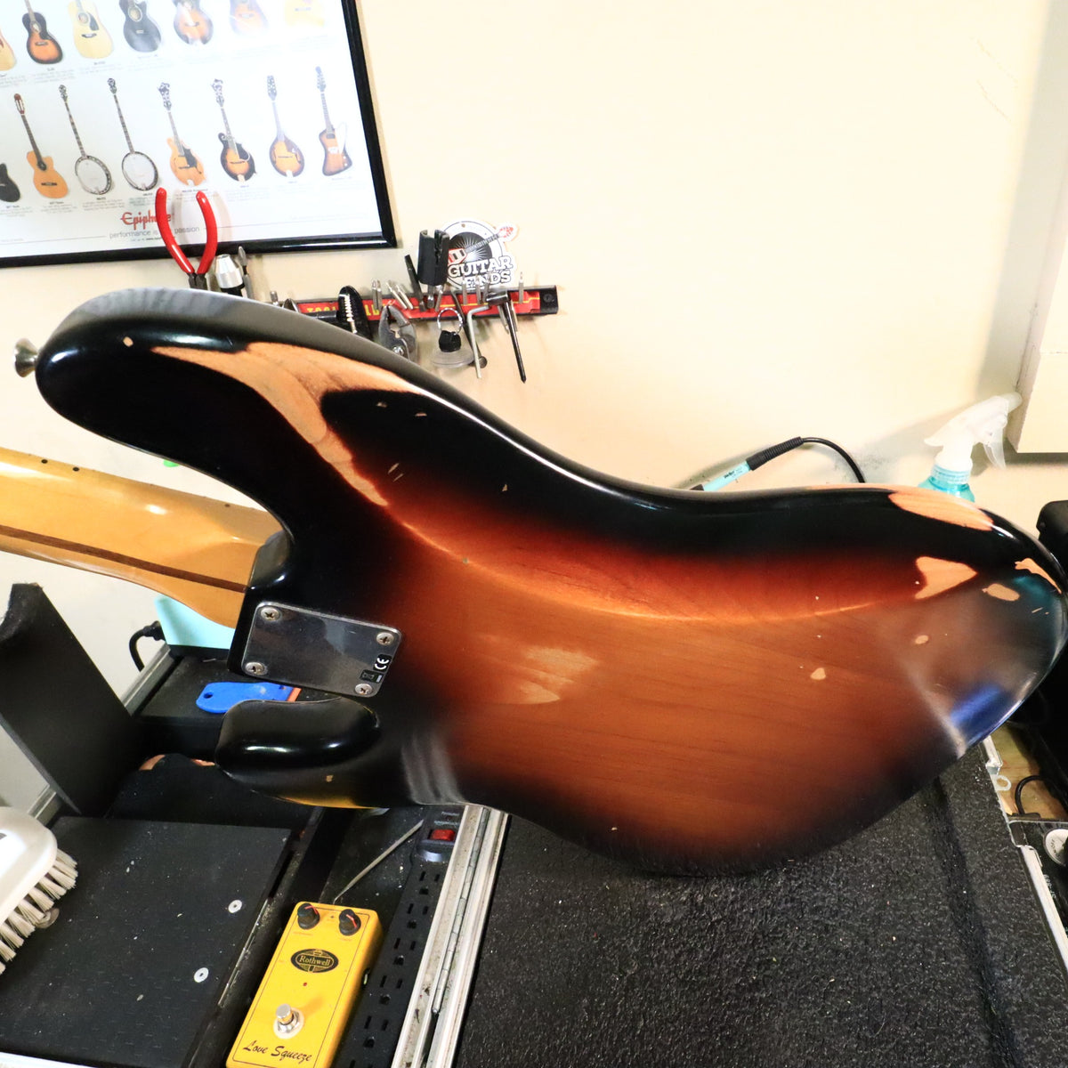 Angled back view of the distressed body on the workbench.