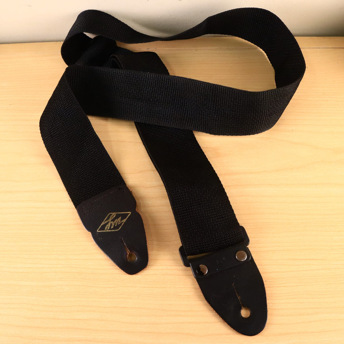 Overview shot of the complete black LM nylon guitar strap.
