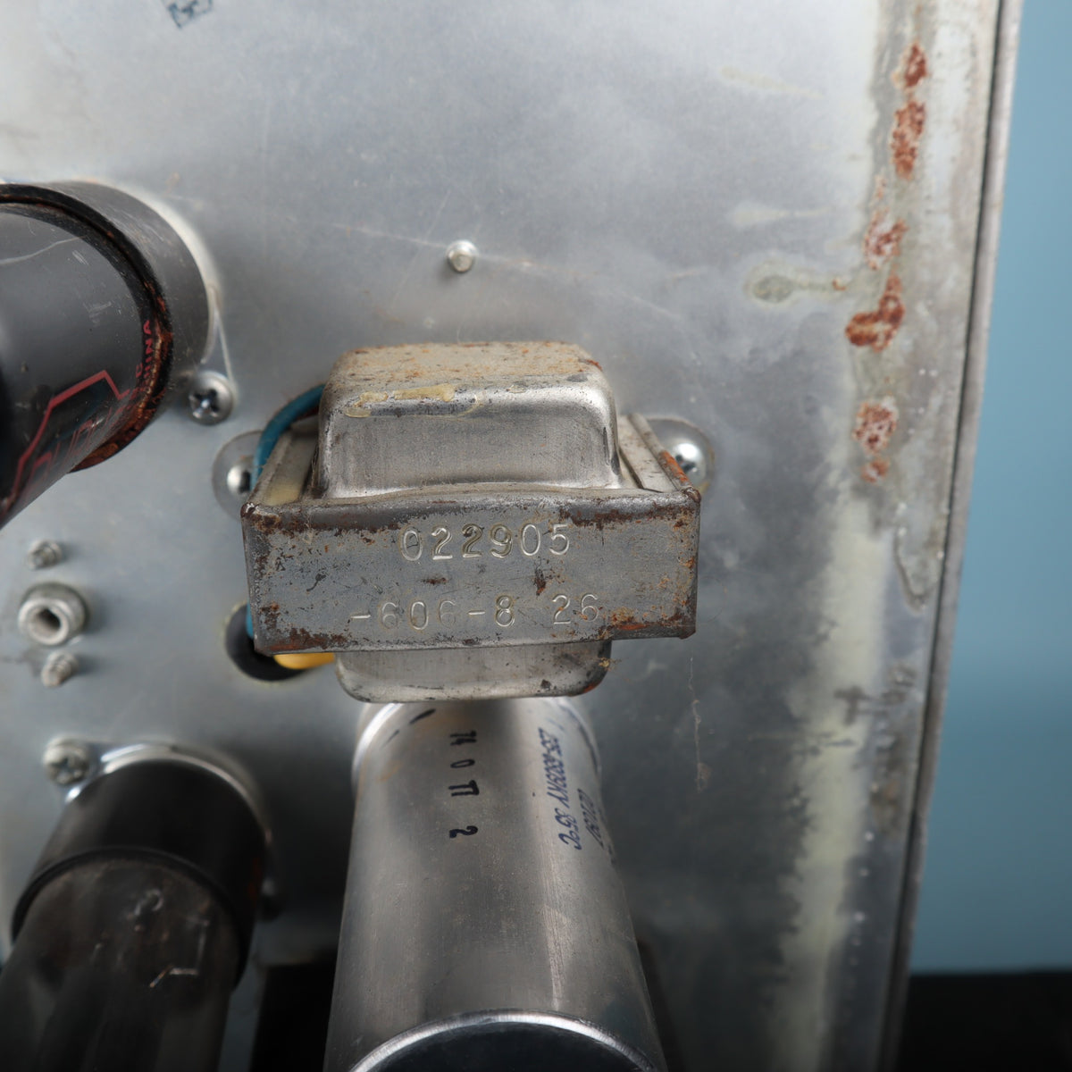 Rear view of the open-back cabinet showing speaker and two-prong power cable.