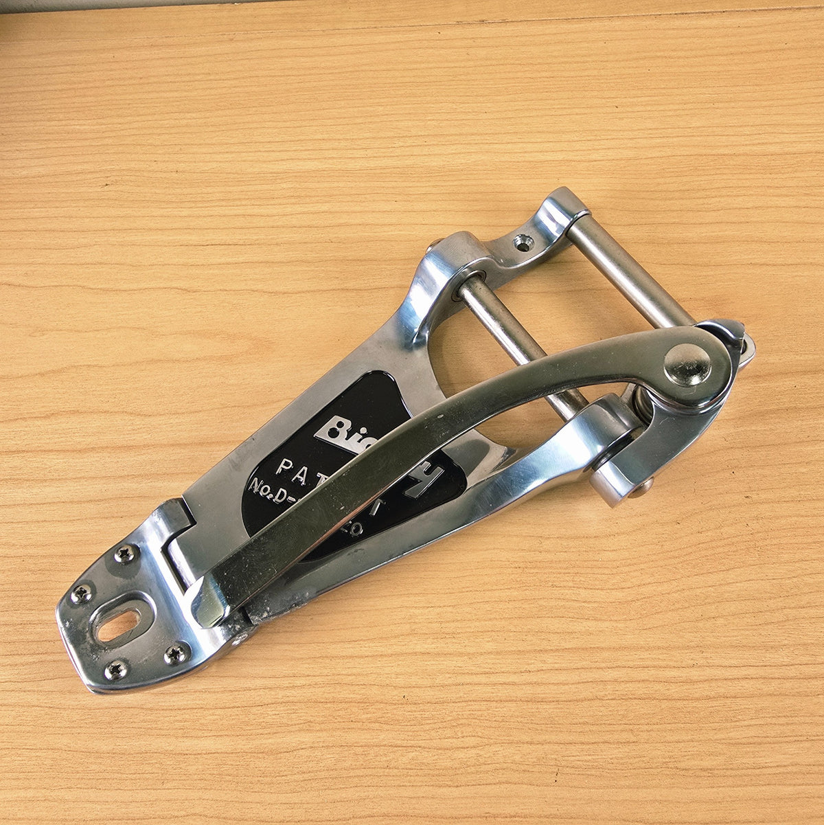 Angled view of the tailpiece with the vibrato arm rotated over the body.
