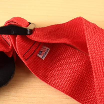 Close-up of sewn-in Made in USA tag and plastic adjustment buckle on red GHS strap.