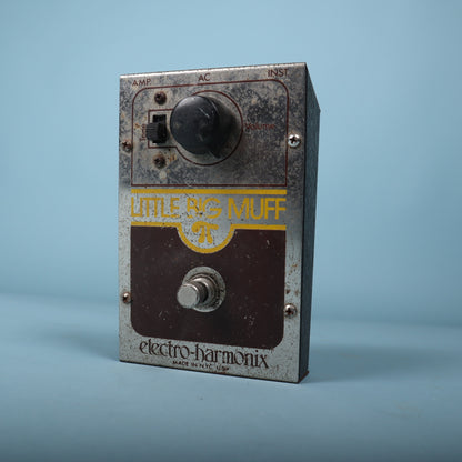 Angled front view showing the volume knob, tone switch, and footswitch.