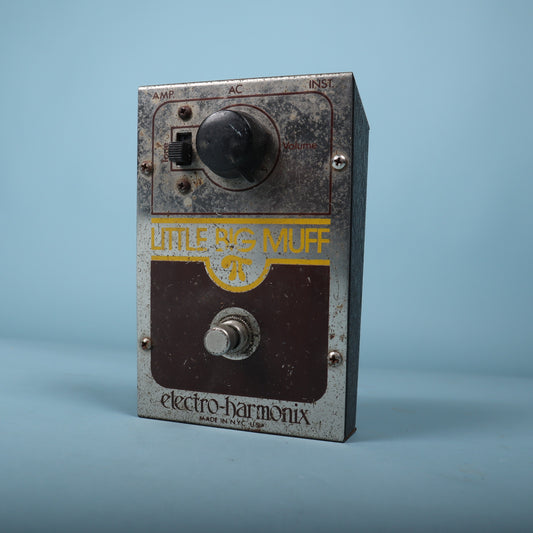 Angled front view showing the volume knob, tone switch, and footswitch.