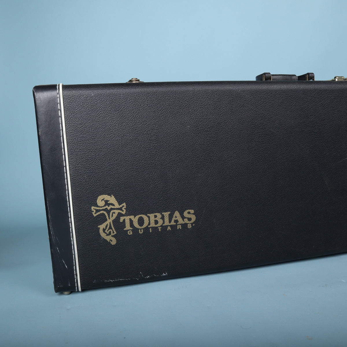 Tobias hardshell bass guitar case exterior logo closeup with white piping