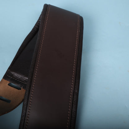 Close-up of the smooth dark brown leather and perimeter stitching on the padded section