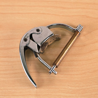Angled view of the closed Hamilton KB19A capo displaying the amber sleeve.
