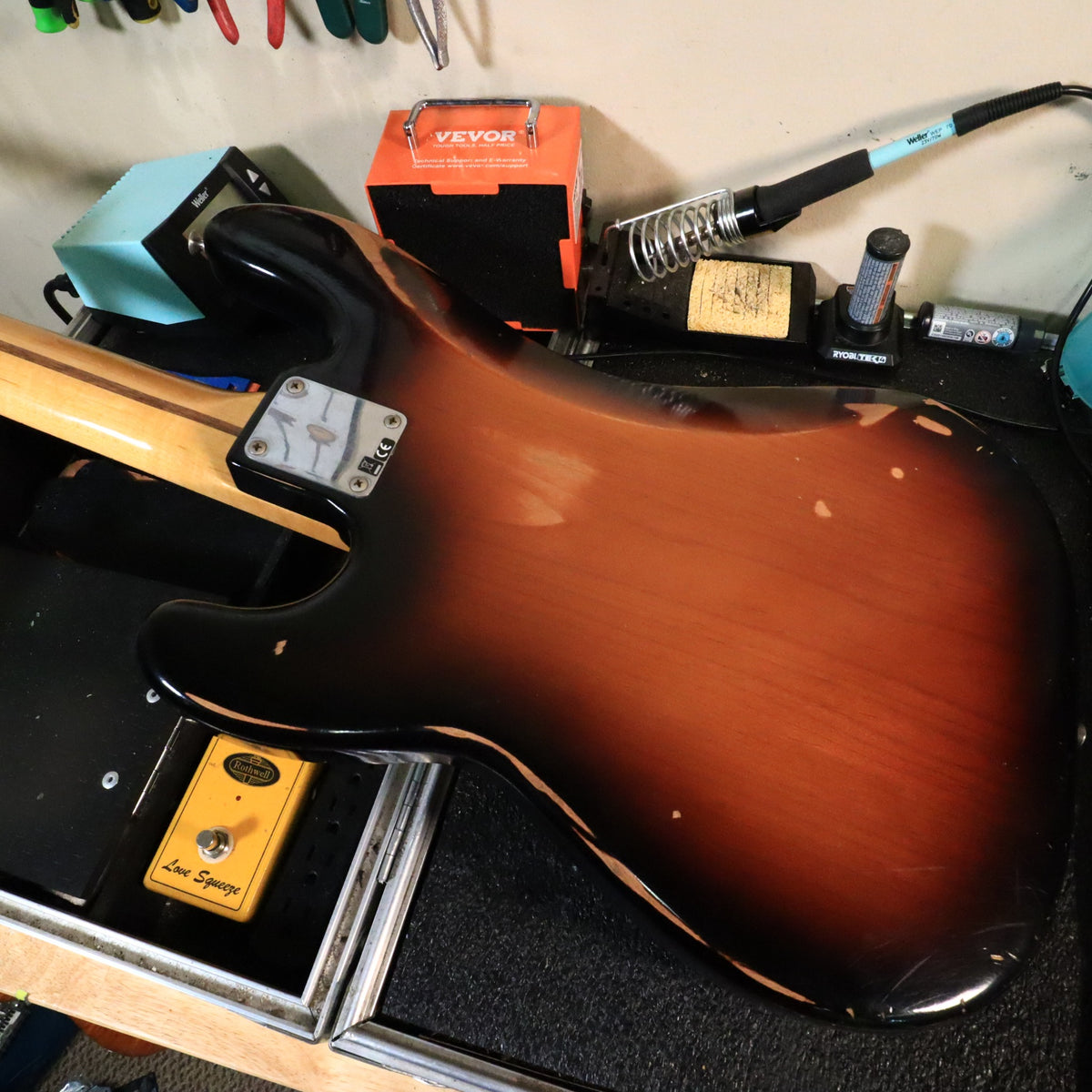 Back of the sunburst body resting flat on the workbench showing tummy cut wear.