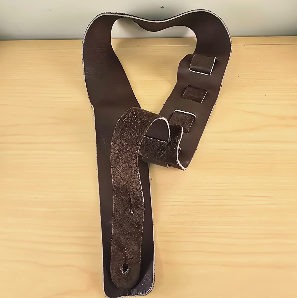 Rear view of the Ernie Ball strap showing the ladder adjustment loops and suede back