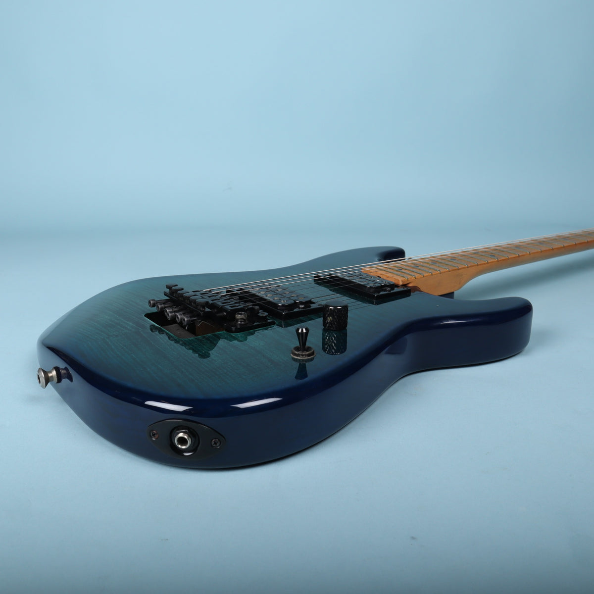 Bottom angled view of guitar body and output jack