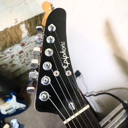 Headstock front close-up showing string trees and Epiphone logo.