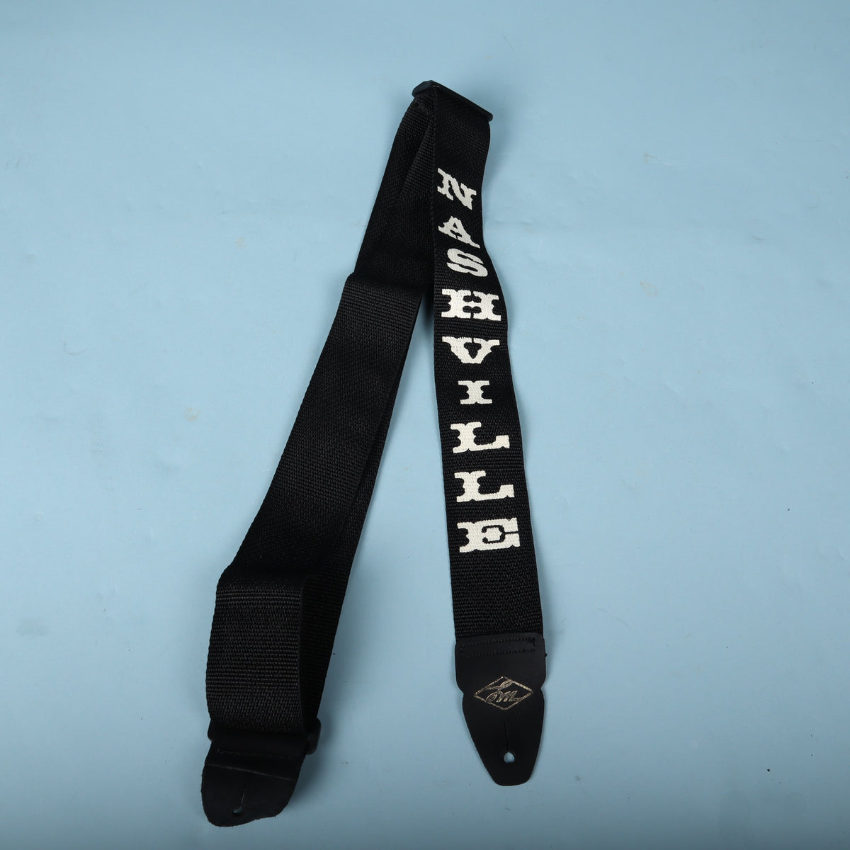 Folded LM Products Nashville guitar strap displaying the white embroidered lettering