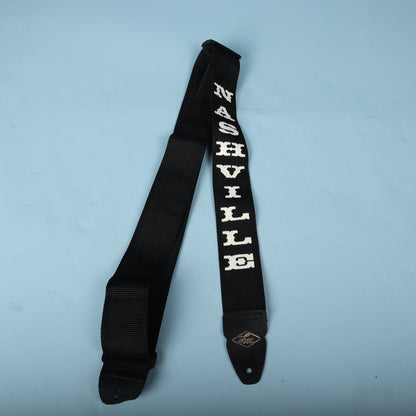 Folded LM Products Nashville guitar strap displaying the white embroidered lettering