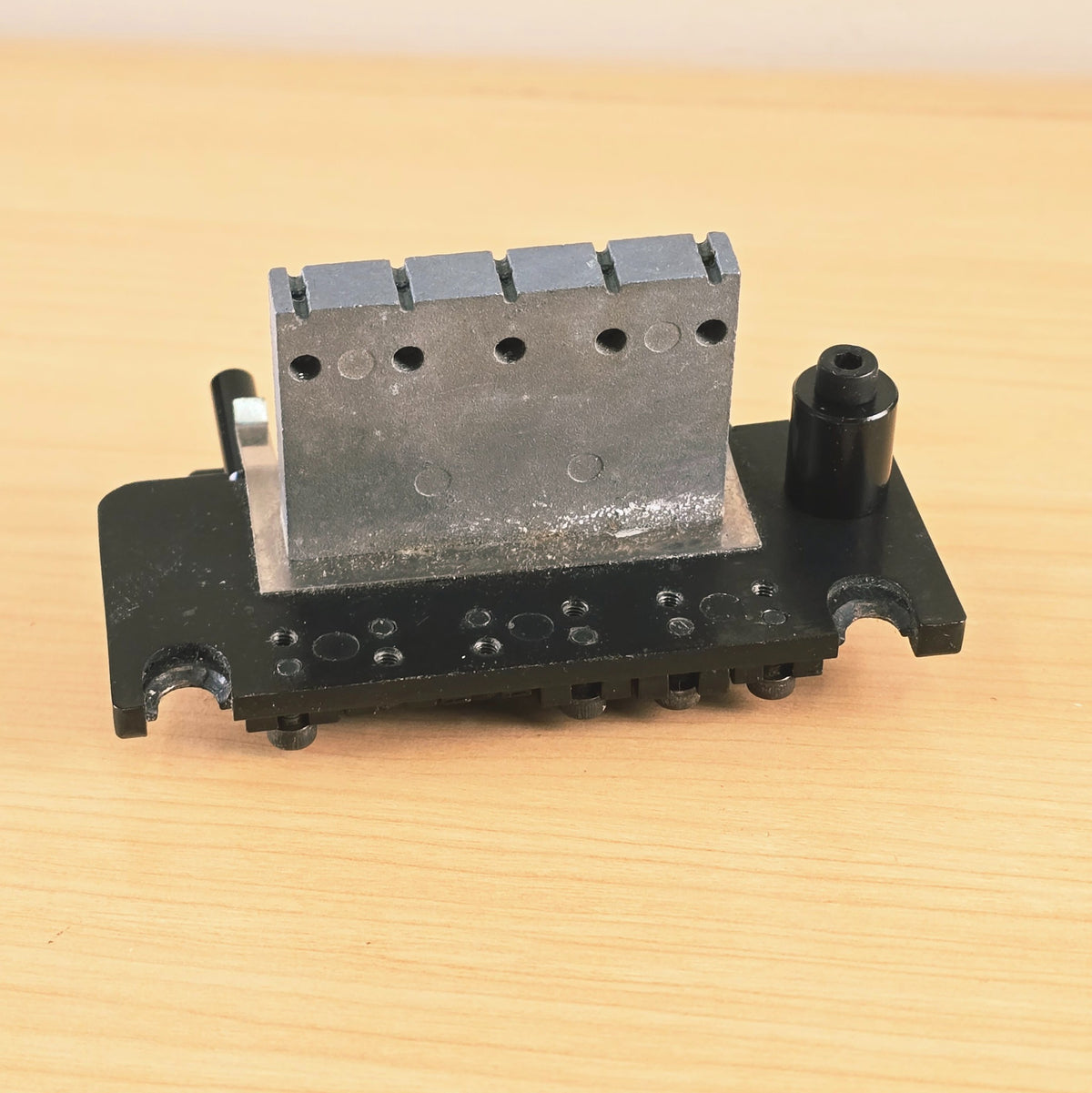 Underside view showing the sustain block and baseplate mounting points.