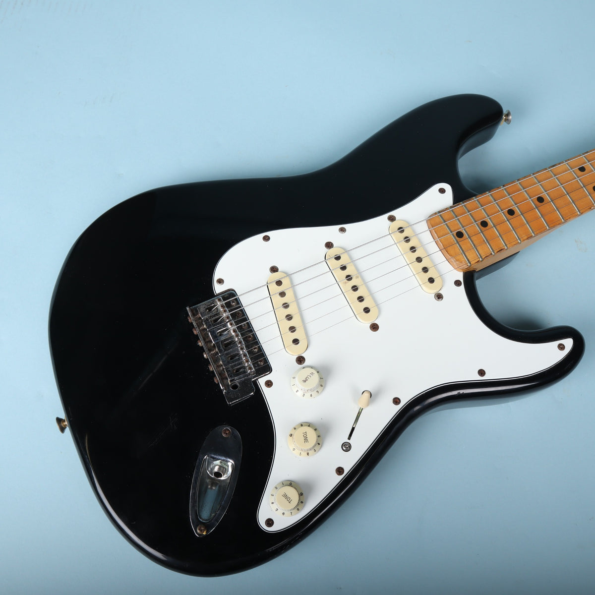 Angled top view focusing on pickups, bridge, and controls