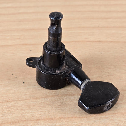 Top-down angled view of the Jackson tuner showing the string post, collar, and button screw.