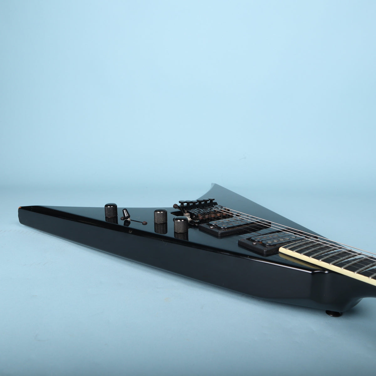 Low side perspective along the treble side of the body displaying the control knobs