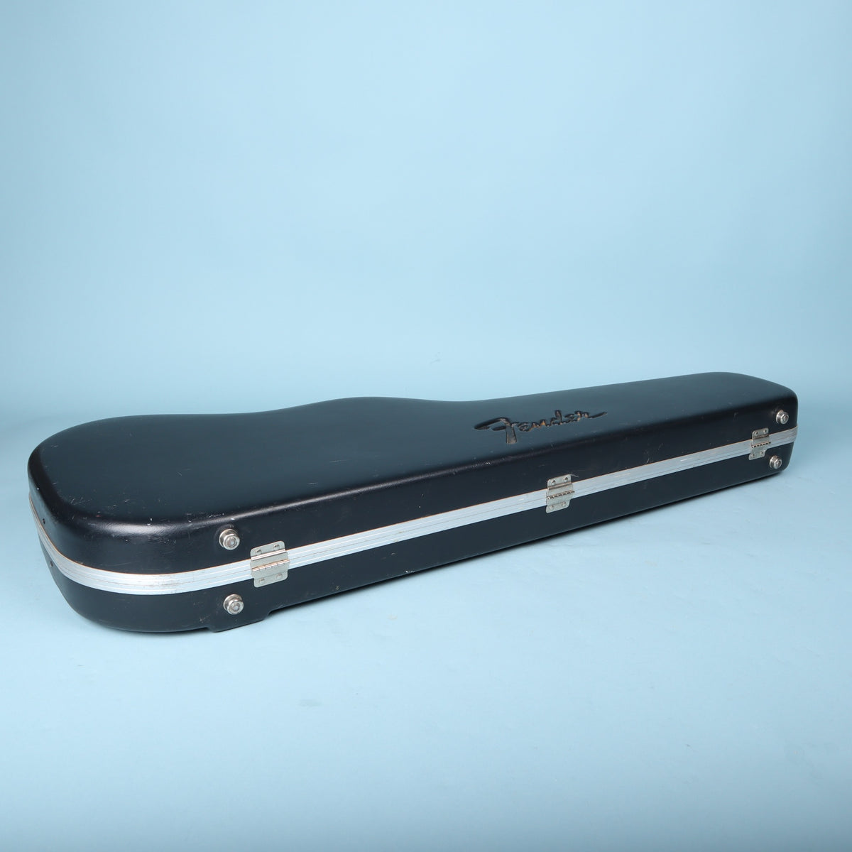 Hinge side view of Fender molded case showing metal hinges and molded feet