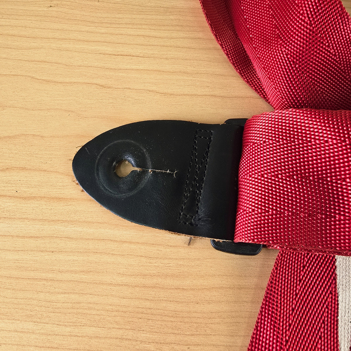 Close up of the second black leather end tab with strap button slot