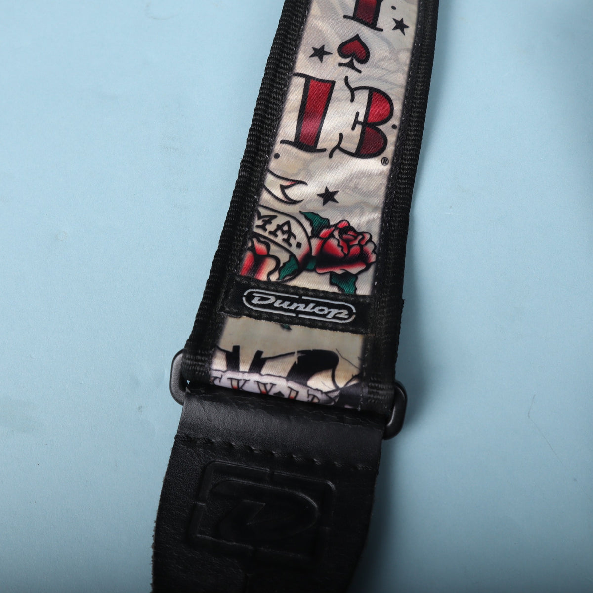 Detail of the stitched Dunlop rubber logo badge and black leather end tab