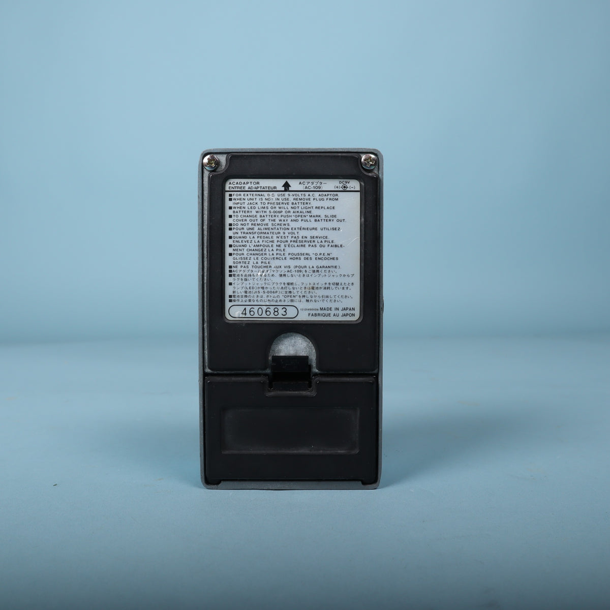 Bottom view showing the factory specification label, serial number sticker, and battery door