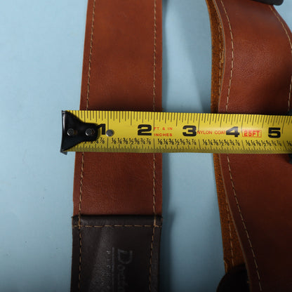 Measuring tape aligned across the strap body displaying 2.5-inch width.