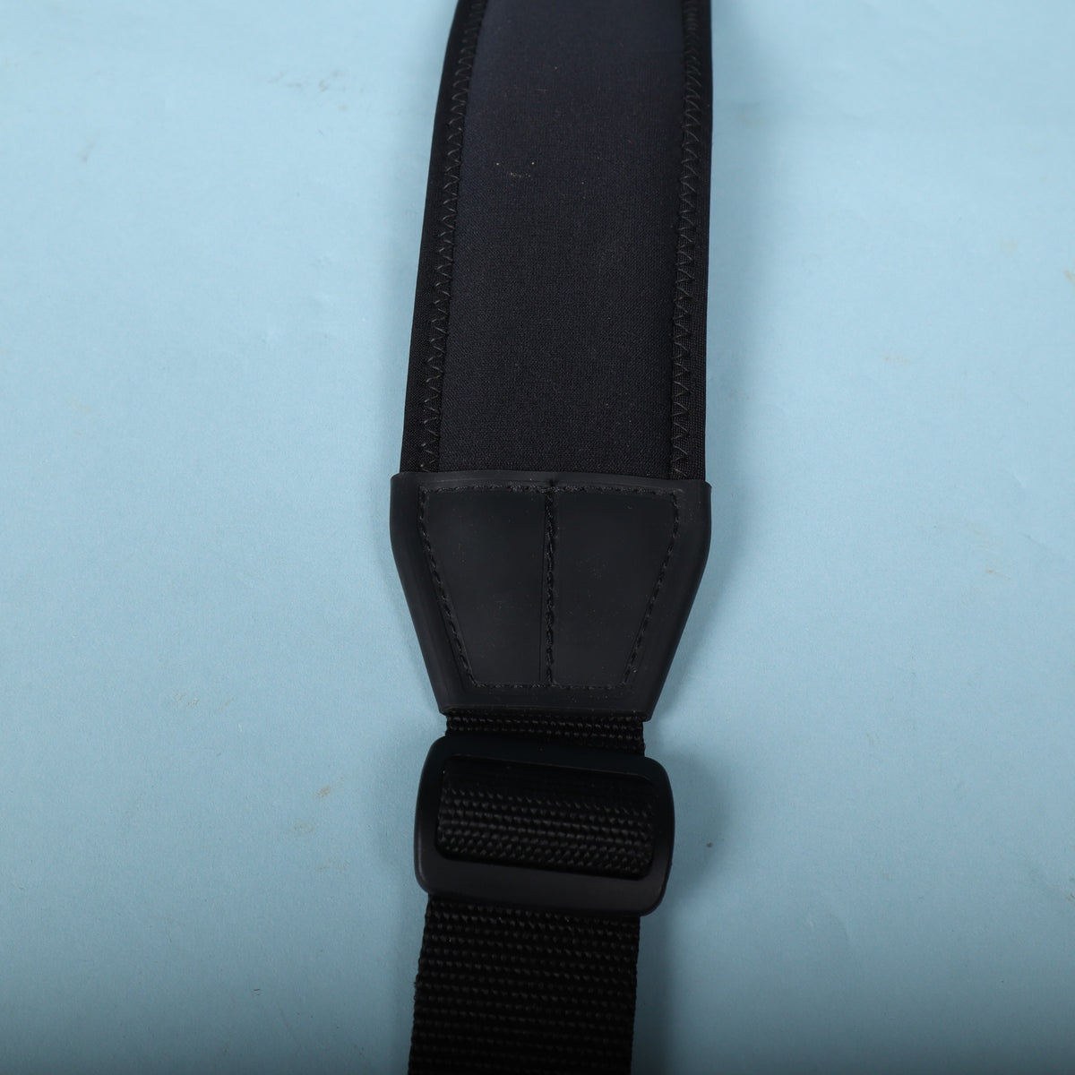 Detail of the molded plastic transition piece and adjustment slider on the strap.