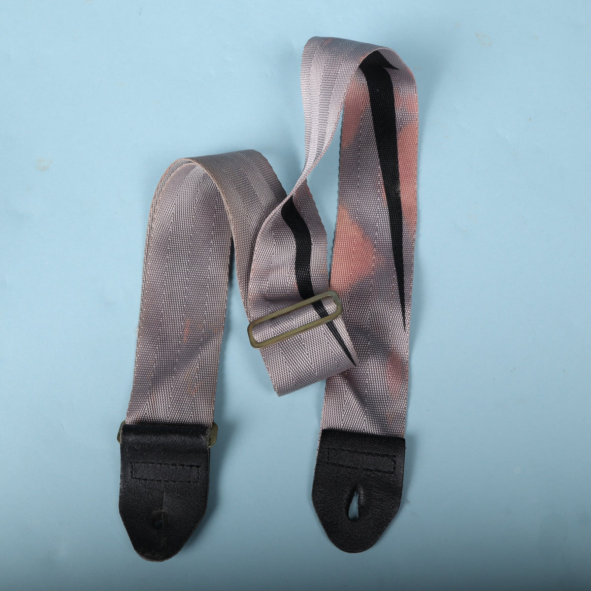 Overhead view of the strap folded with metal adjustment slider visible.