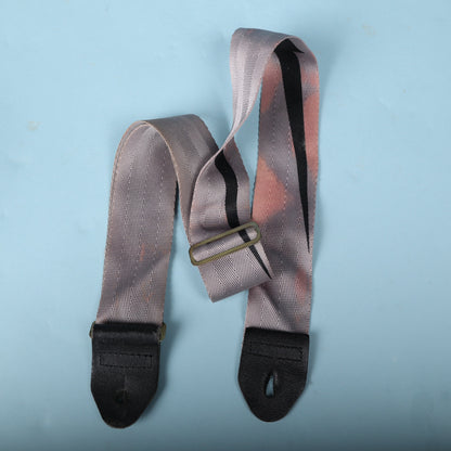 Overhead view of the strap folded with metal adjustment slider visible.