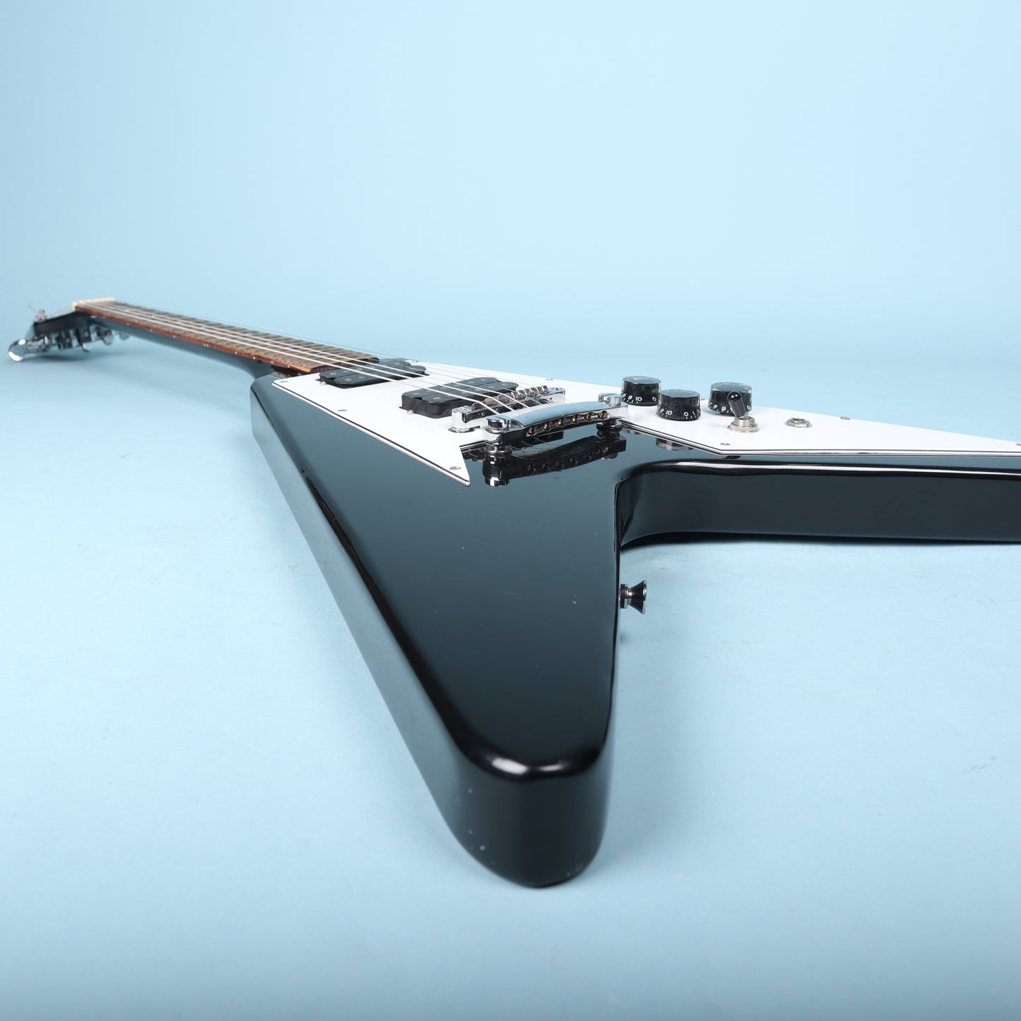 Flying V Style Electric Guitar in Black with White Pickguard